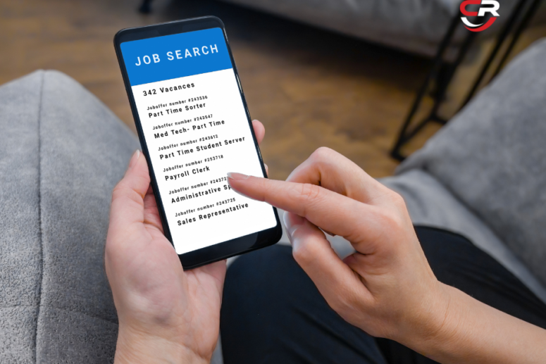 A person scrolling on their phone looking for available job roles, and job search guide